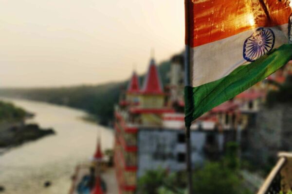 Das Titelbild zeigt die Nationalflagge Indiens von dem Panorama eines Flusses, der durch eine Stadt läuft.